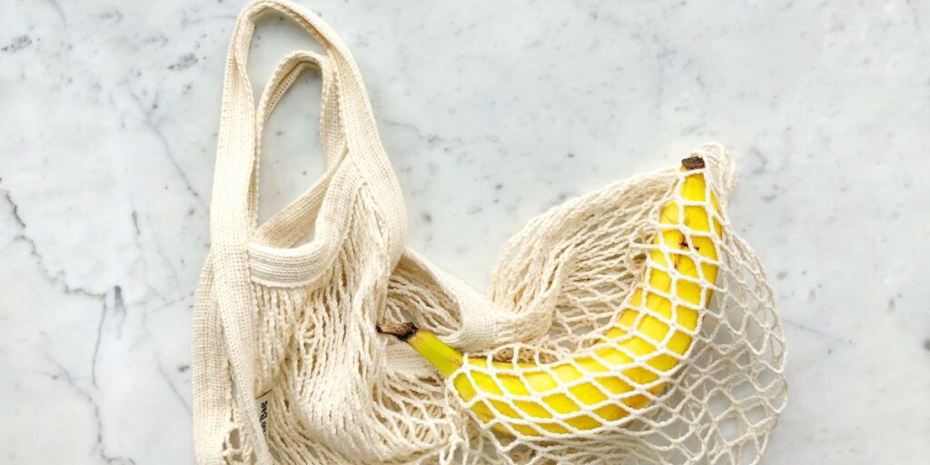 Banana in a net shopping bag