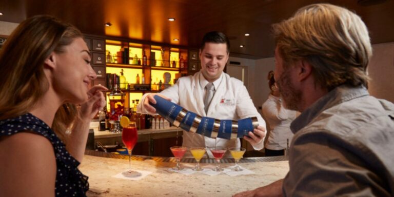 A bar tender on Carnvial Cruises serving cocktails.