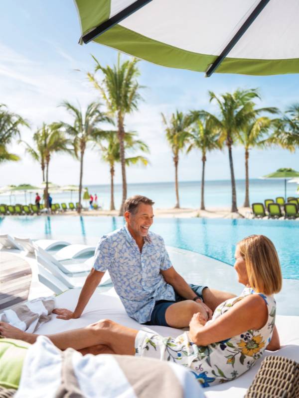 A man sat next a woman by a pool at CoCo Cay .