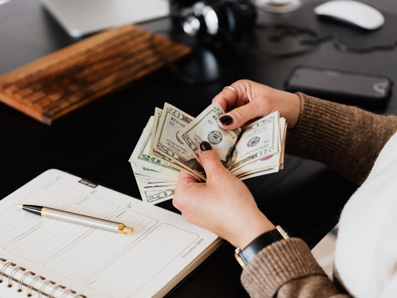 Person counting up the compensation money