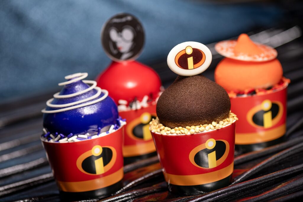 Character-inspired cupcakes: Purple Velvet Sponge Cake with white chocolate mousse; Double Chocolate Fudge Cake with chocolate truffle mousse; Vanilla Marble Sponge Cake with white chocolate mousse; and Orange-Almond Cake with raspberry mousse