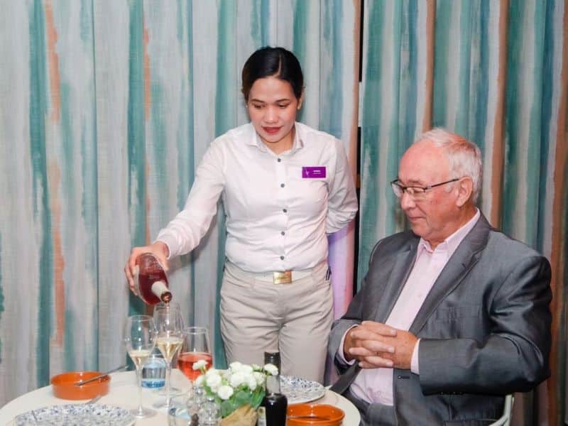 Ambassador Cruise Line crew serving wine