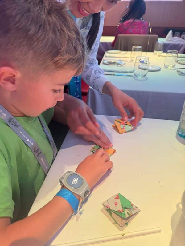 Doing origami at dinner on a Disney cruise