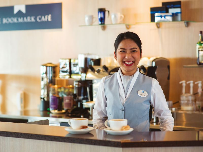 Fang serving coffee in The Bookmark Cafe on Braemar