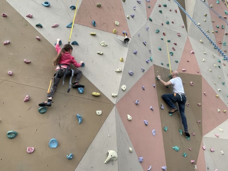 Father and daughter rock climbing