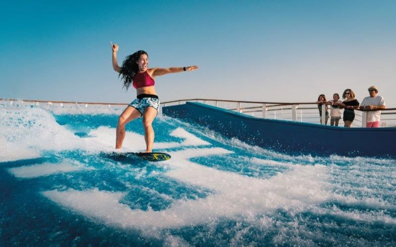 Woman surfing on Harmony of the Seas' FlowRider