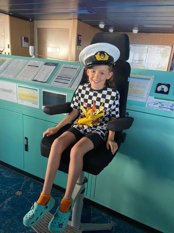 Young girl on the bridge of a cruise ship
