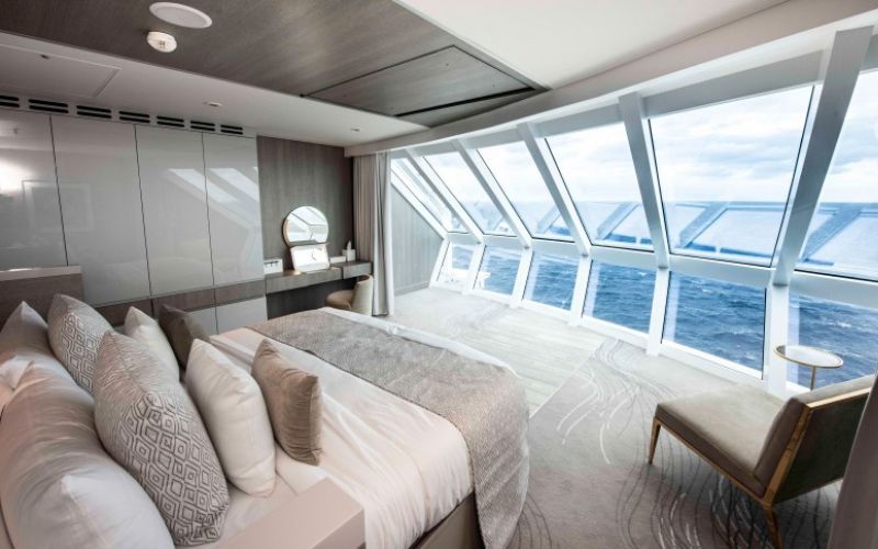 White interior of the iconic suite onboard showing its elegant looking sheets and room design