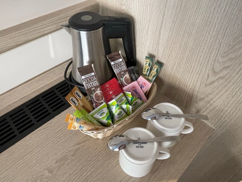 kettle, cups and drink sachets in river cruise ship cabin