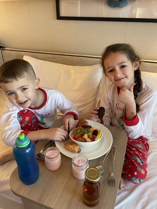 My kids enjoying breakfast in bed on a cruise