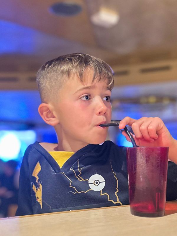 Adam drinking a drink from a red plastic cup on a Marella cruise