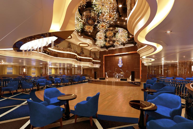 The opulent King's Blues Club on HAL Rotterdam, featuring a grand stage set for live music, plush blue velvet seating, elegant lighting fixtures, and a sophisticated ambiance.