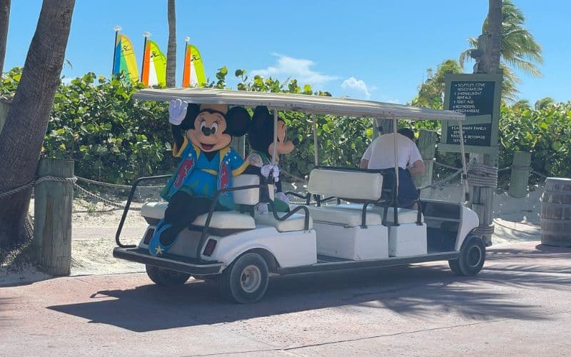 Mickey Mouse and Minnie Mouse riding the golf cart
