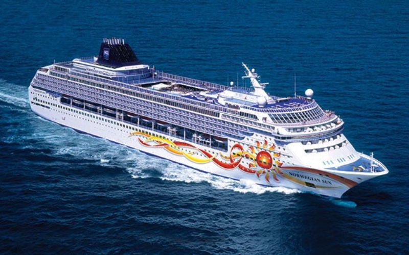 Norwegian Sun NCL with a beautiful sun design on the sides, cruising the sea majestically.