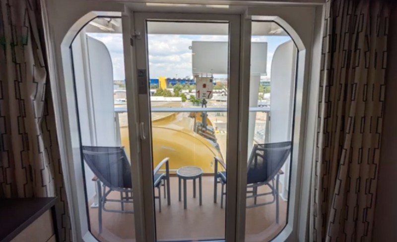 A yellow lifeboat visible from the balcony of an obstructed view room on Anthem of the Seas