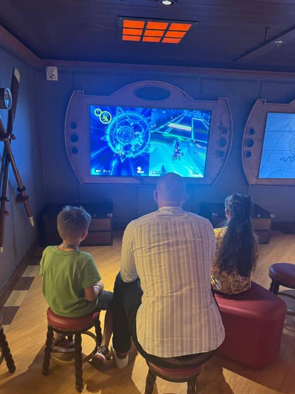Dad and kids playing games in the kids club on a Disney cruise