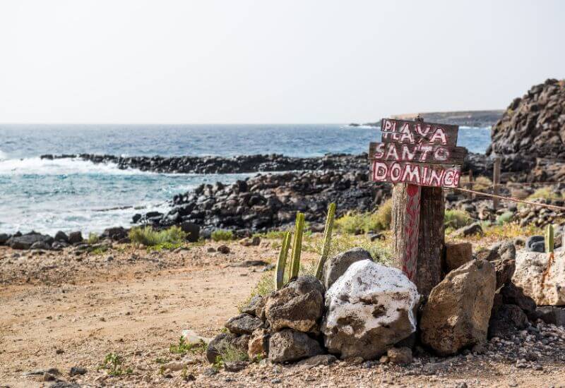 Caribbean beach with a sign saying 'Playa Santo Dominico'