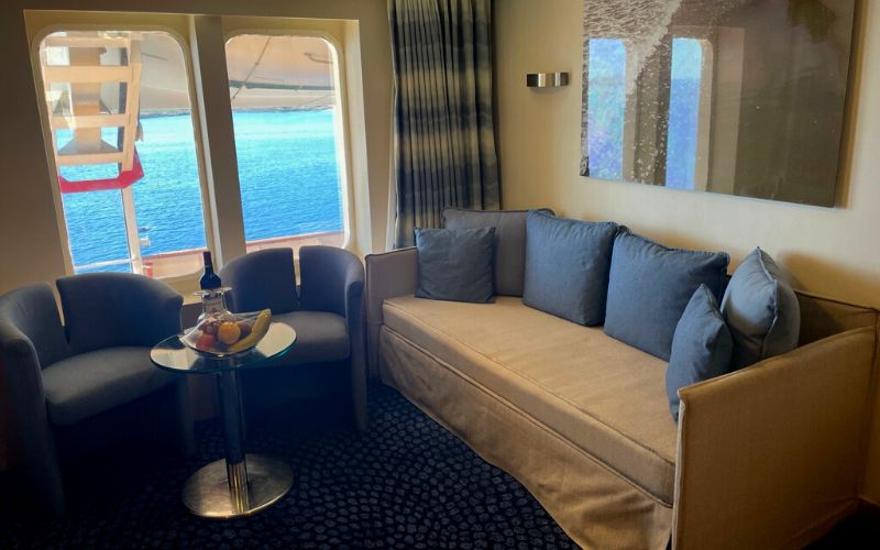Seating area with a big window inside the suite