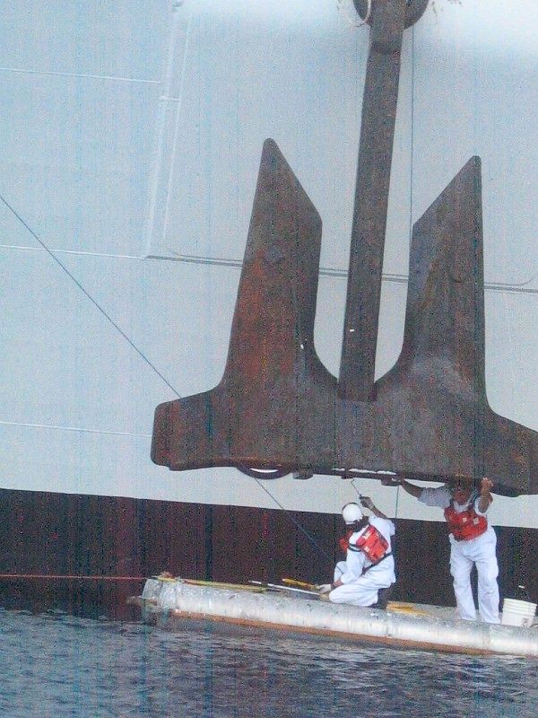 Two men beside the anchor of Norwegian Jewel
