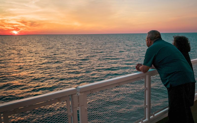 couple watching the sunset while on a lake cruise