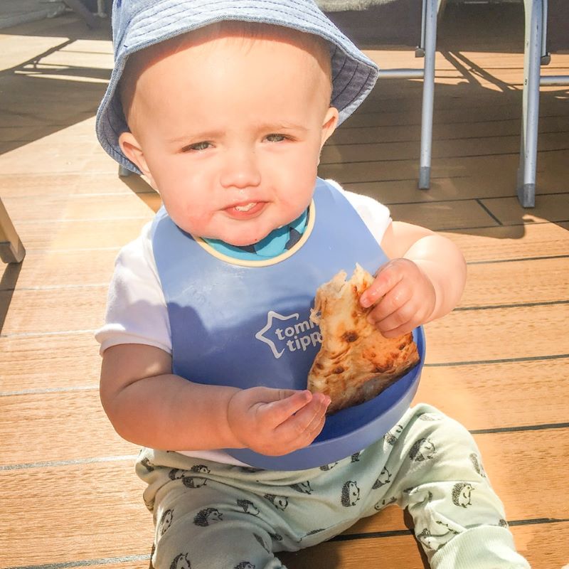 Baby Adam eating Pizza onboard cruise ship