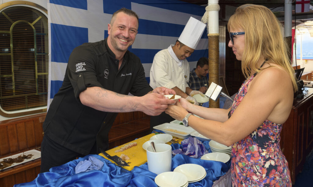 Chef serving food to a guest on Star Clippers