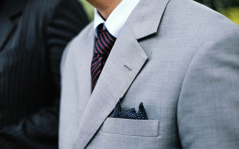Close-up of a man in a sharp suit and tie, exuding professionalism and style in formal wear.