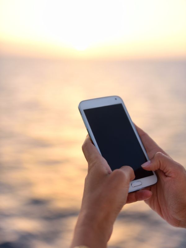 Holding a phone at sea