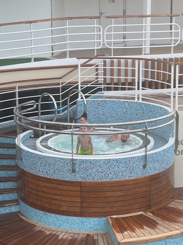 My kids and their dad in a hot tub on Azura