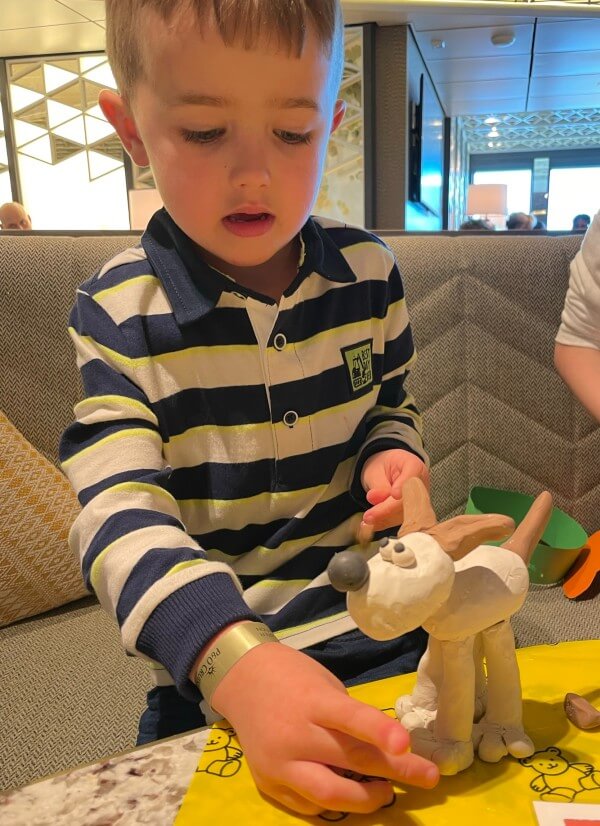 Child making Wallace and Gromit models at The Club House on Iona