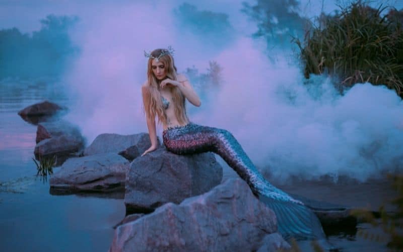 Woman dressed as a mermaid on rocks