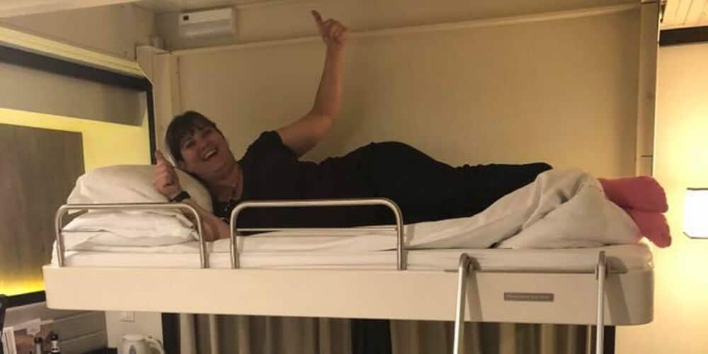 Woman on Pullman bed in P&O Britannia cabin