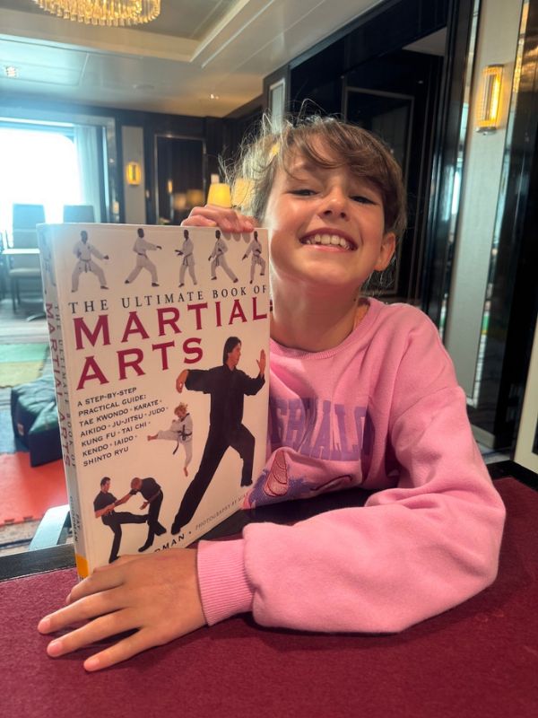 my daughter reading a book on a cruise