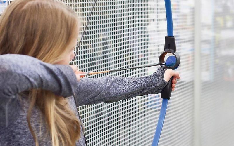 a girl holding archery bow