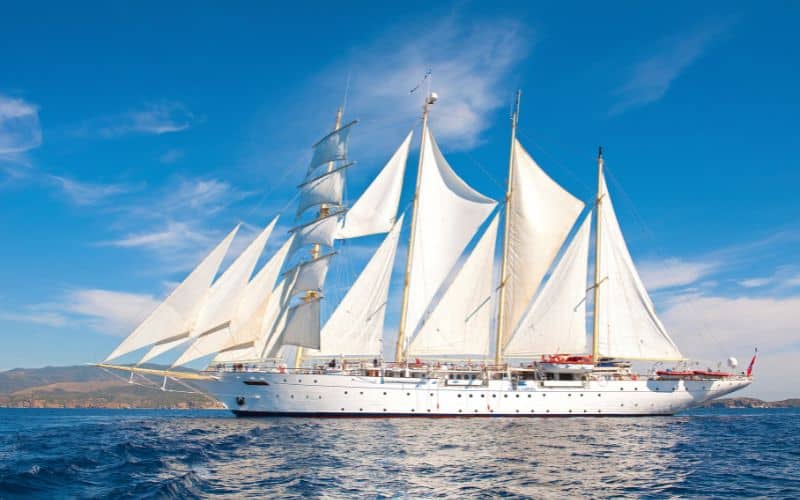 Star clipper under the bright blue sky while cruising the sea